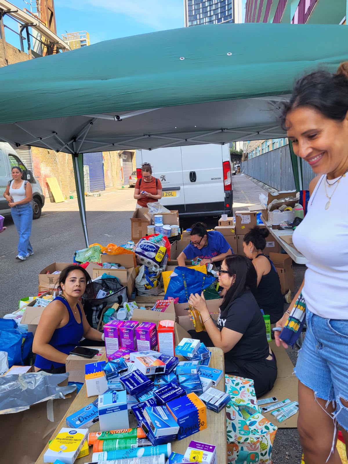 Volunteers sorting donated items by category.