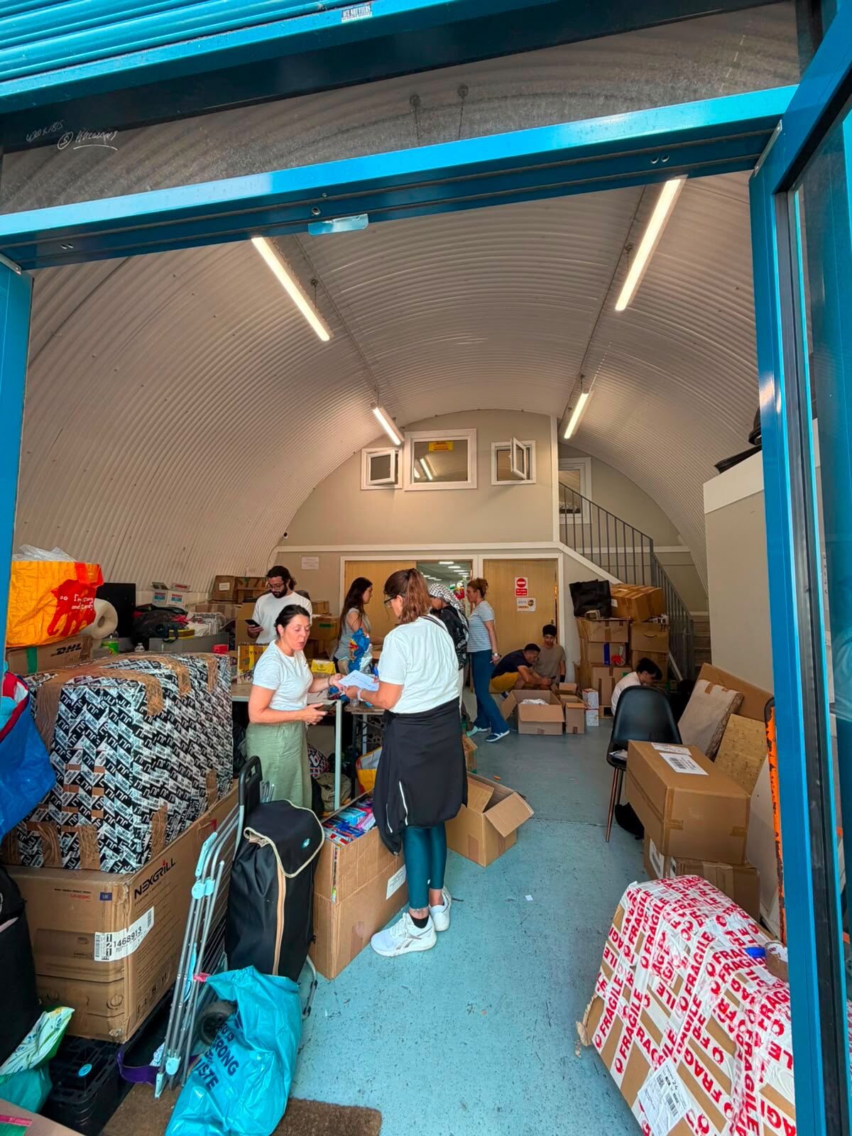 Volunteers sorting donated aid in our London warehouse