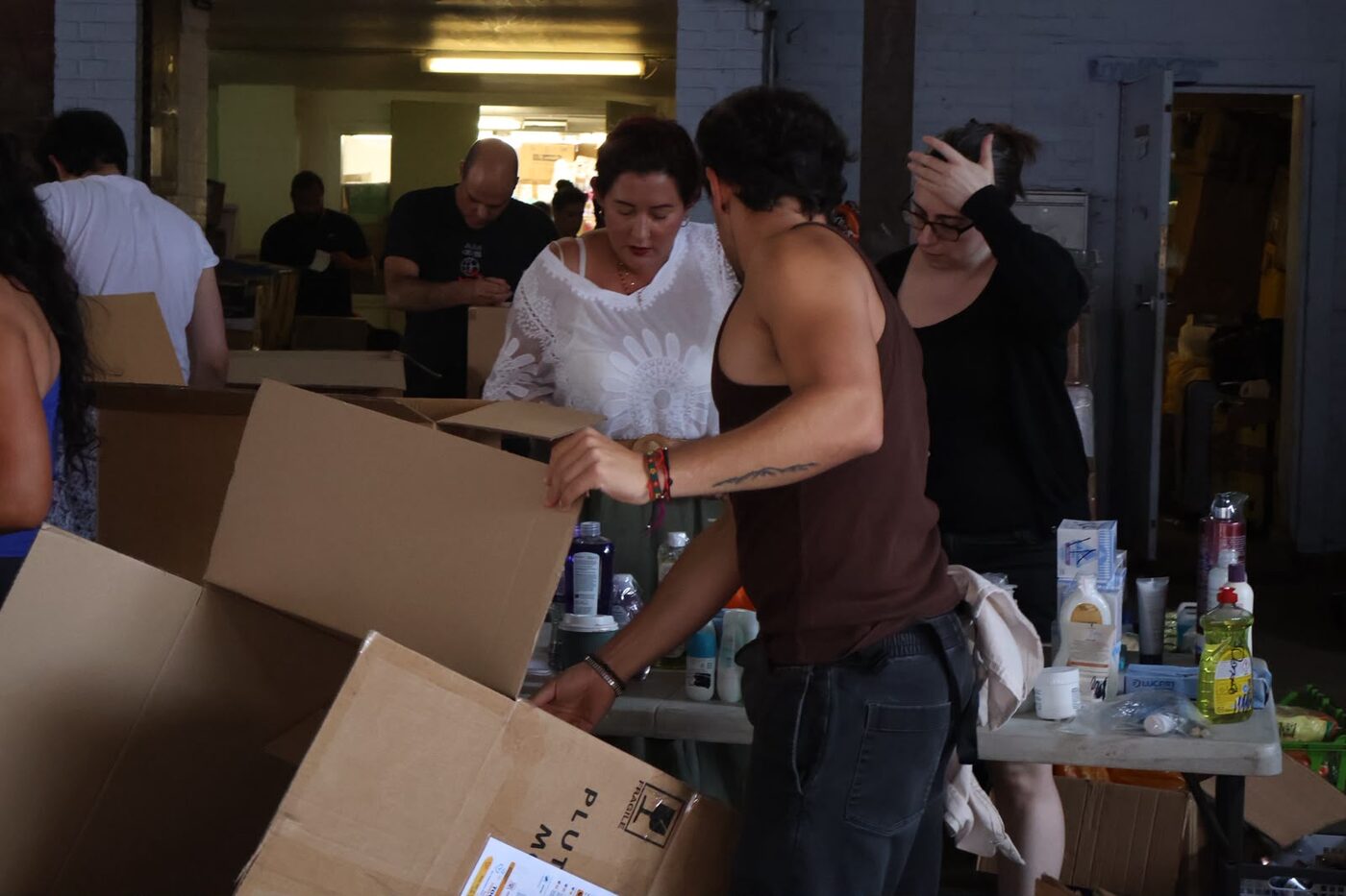 Sorting and packing donations, London, August 2026