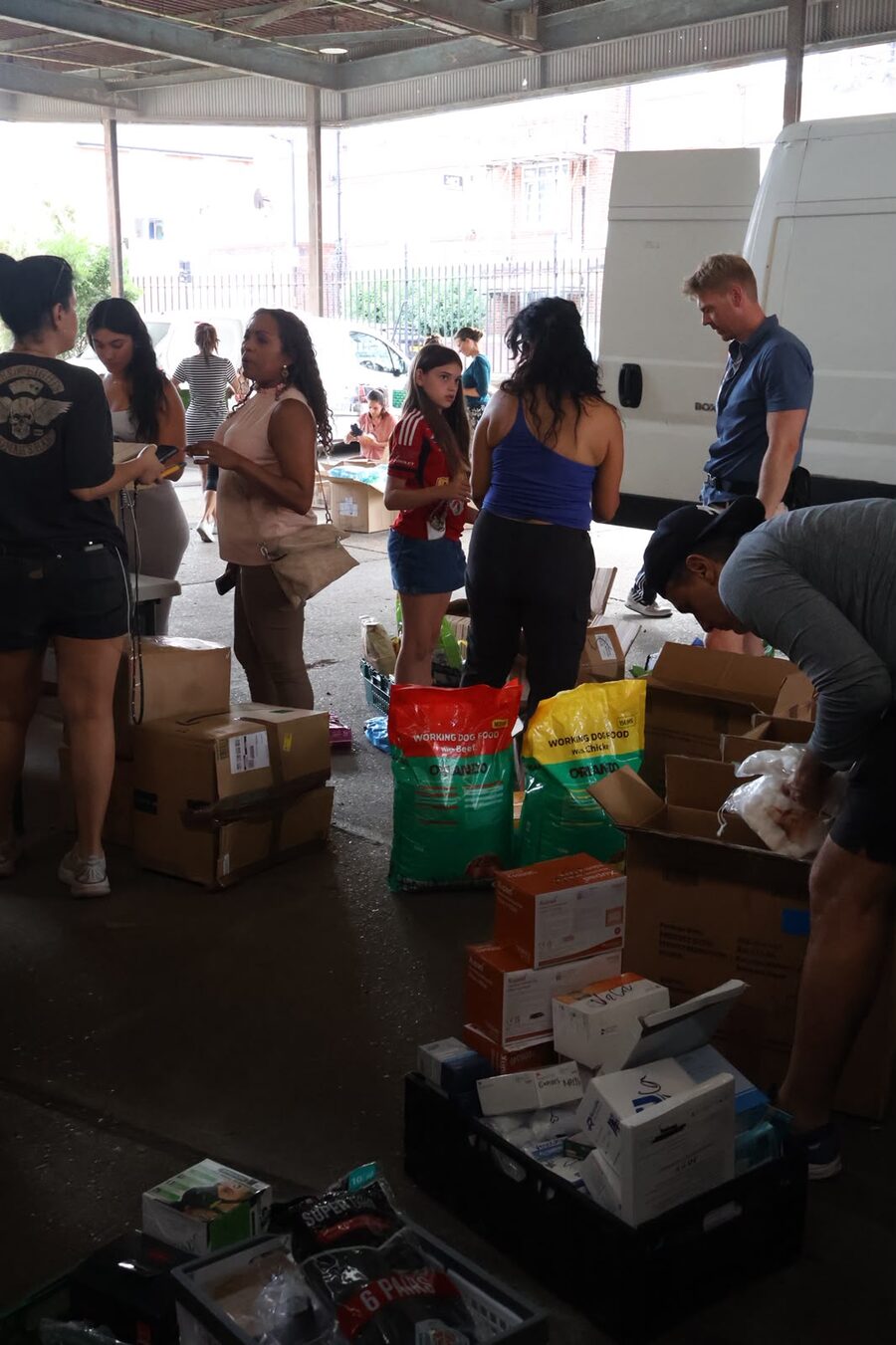 Volunteers sorting donated aid, London, August 2026